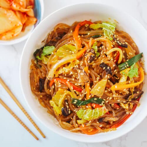 spicy vegan chapchae with kimchi on the side