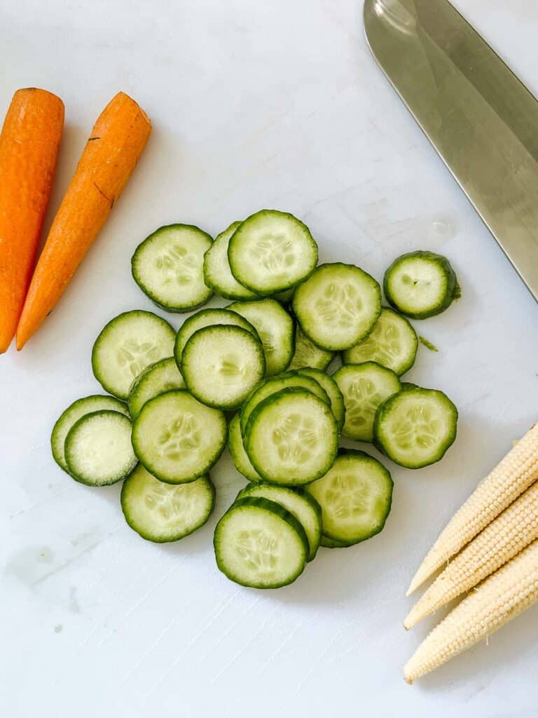 sliced cucumbers with baby corn and carrots