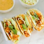 3 tacos de camaron in a taco holder