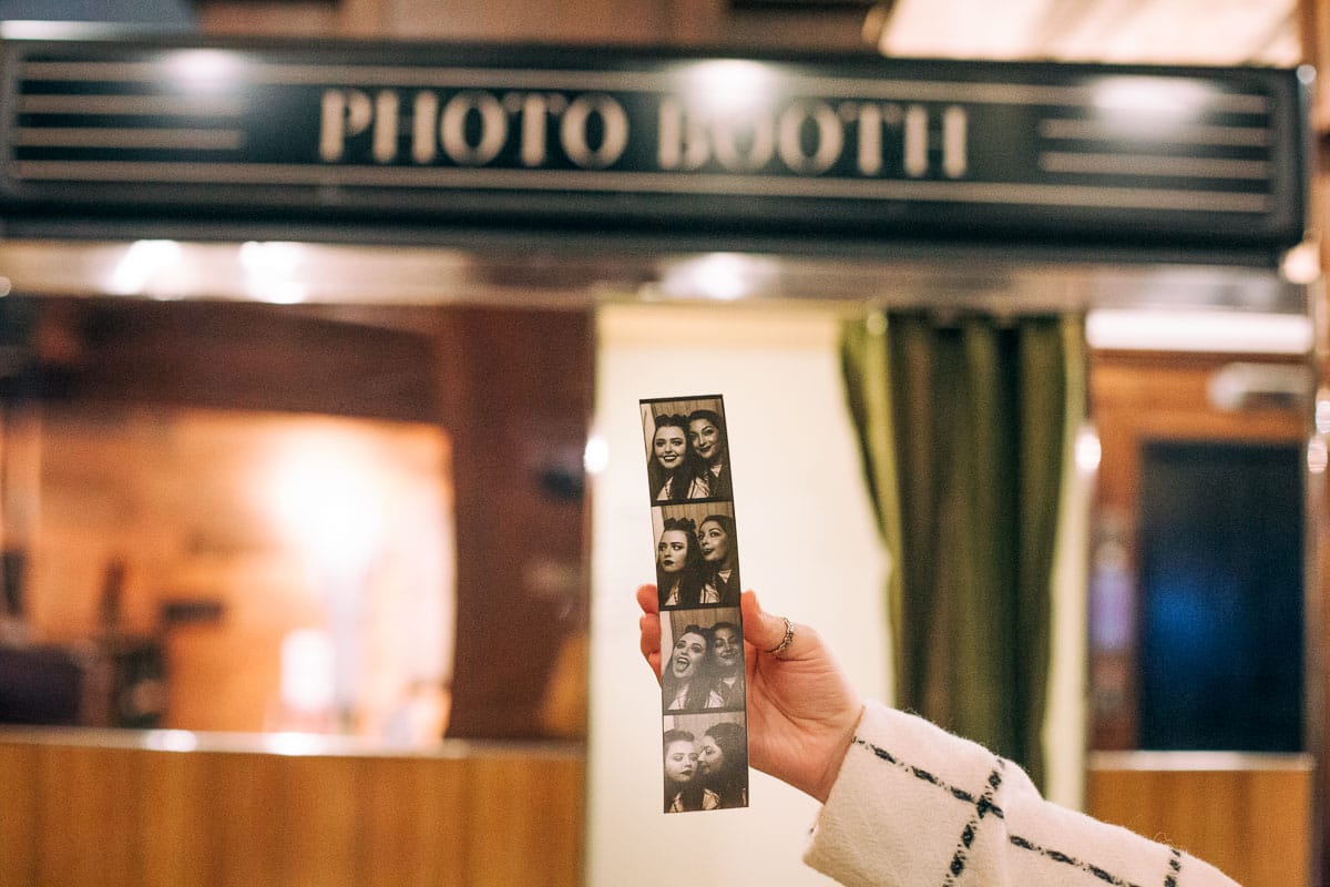 hand holding photo booth strip in front of Ace Hotel Photo Booth
