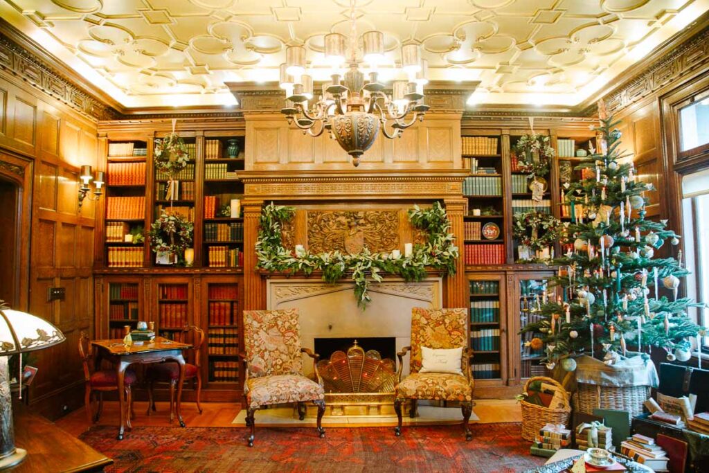 interior shot of Pittock Mansion featuring fireplace and Christmas decor