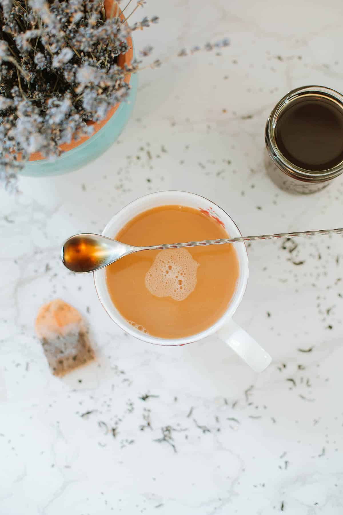 tea with spoonful of syrup, jar or earl grey syrup, tea bag, and pot of lavender