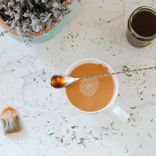 tea with spoonful of syrup, jar or earl grey syrup, tea bag, and pot of lavender