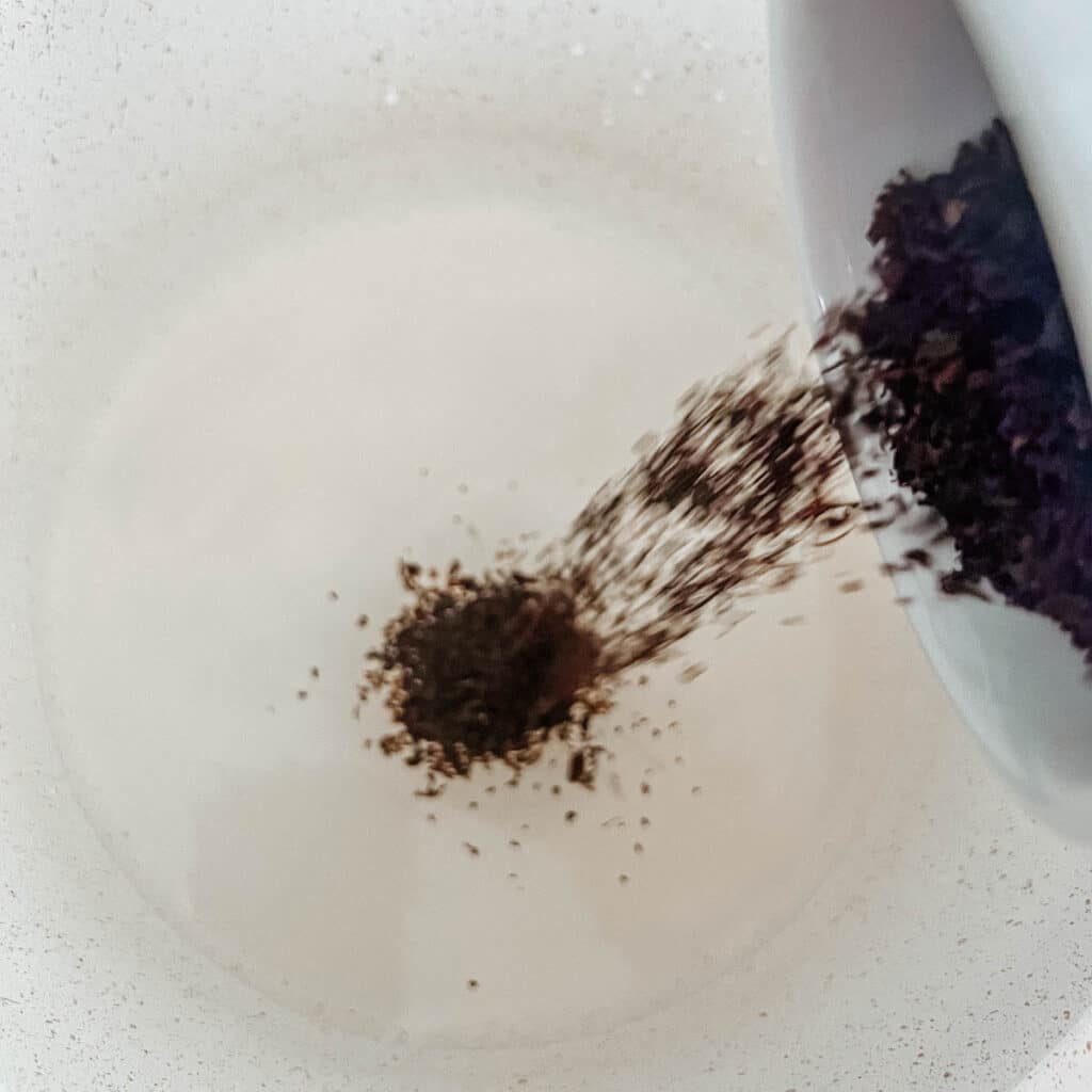 earl grey tea leaves being poured into pot