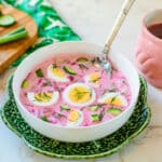 Šaltibarščiai (Lithuanian Pink Soup) with spoon, tea in flamingo cup, and veggies on cutting board