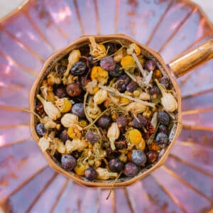 loose leaf juniper berry tea ingredients in purple teacup