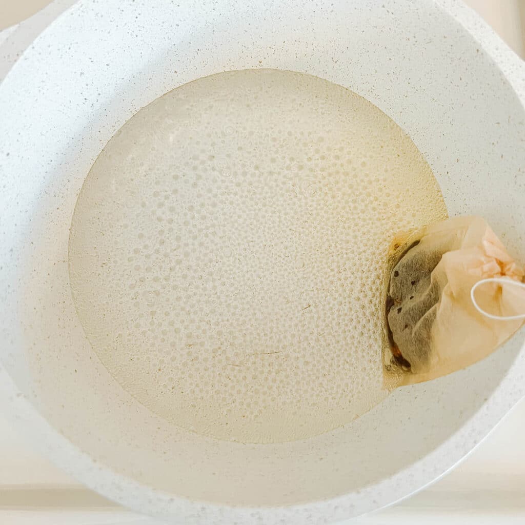 sachet of berries in water in pot