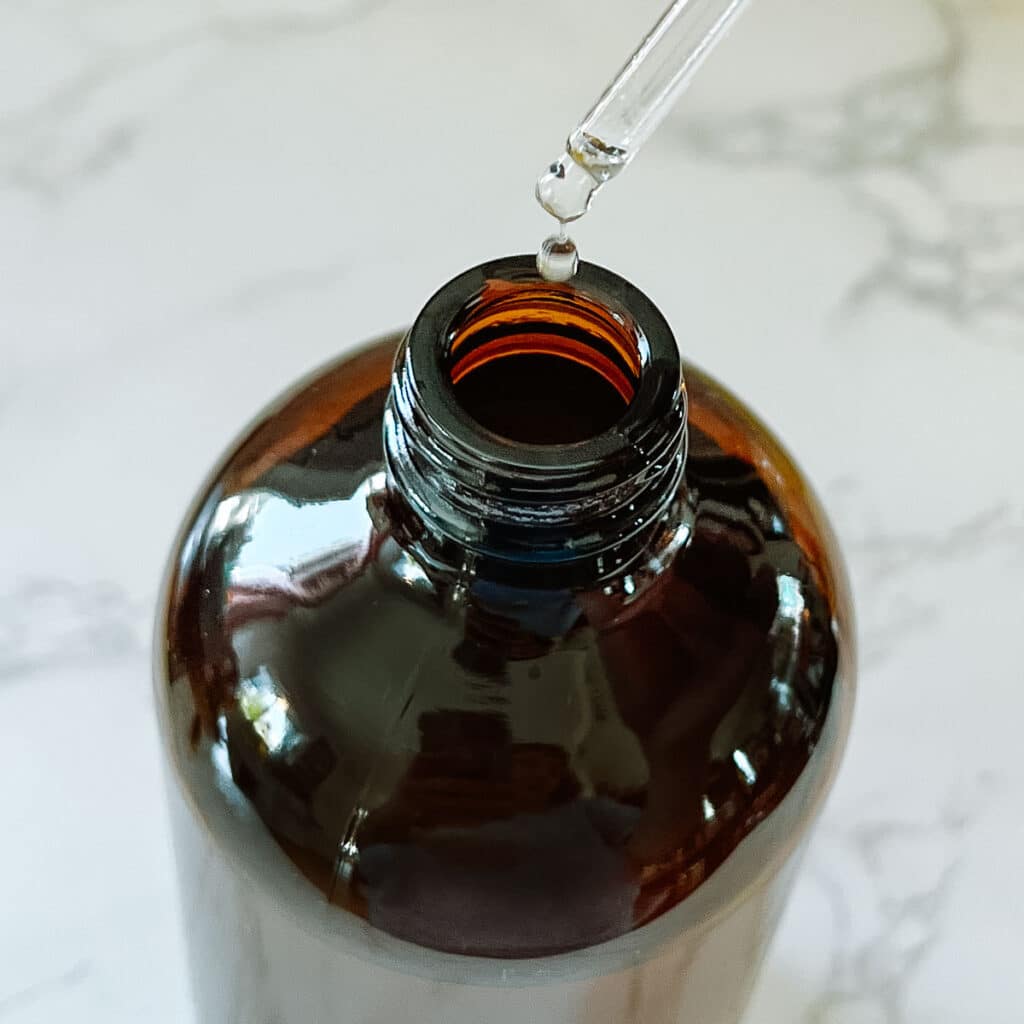 adding essential oils to bottle
