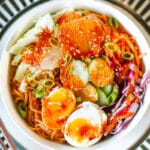 bibimmyeon topped with veggies, sauce, and jammy eggs.