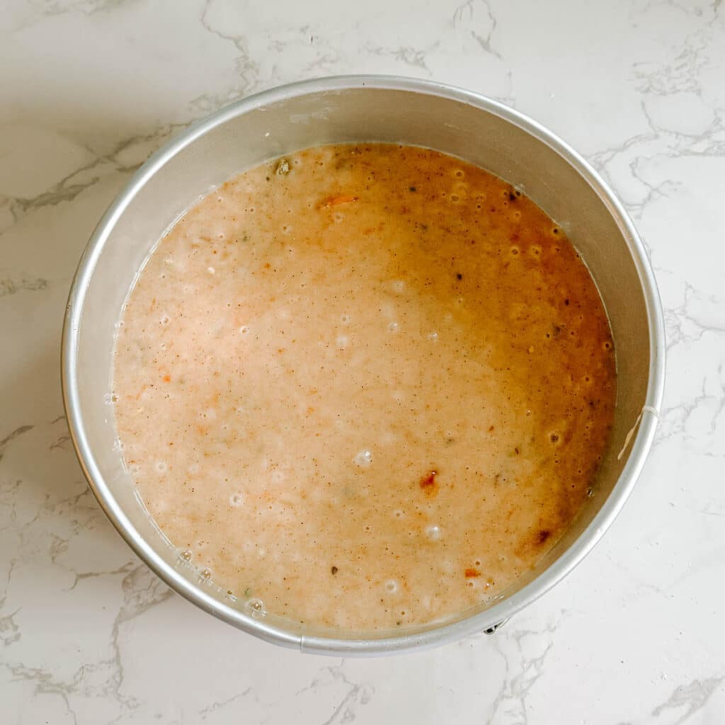 persimmon cake batter in cake pan.