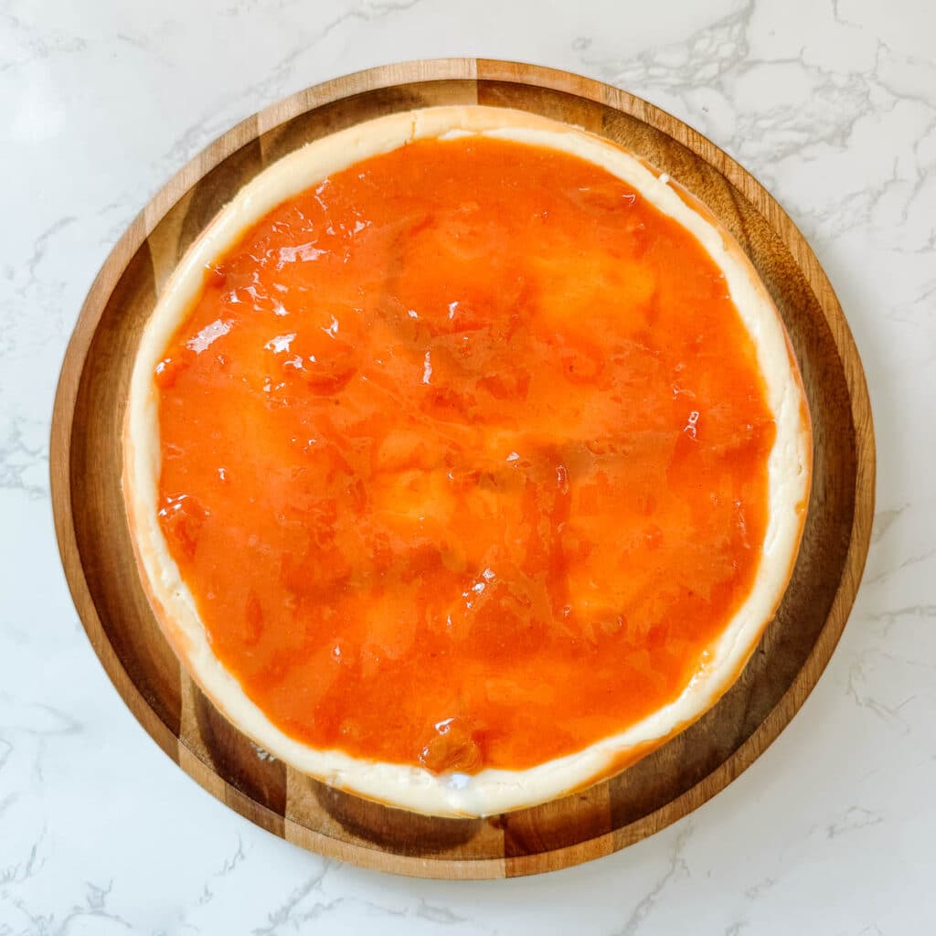 cheesecake layer topped with persimmon jam.