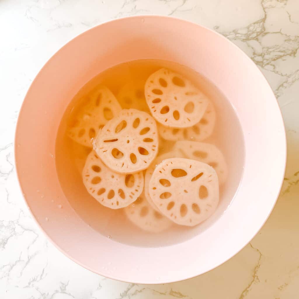 lotus root fries soaking in water and vinegar.