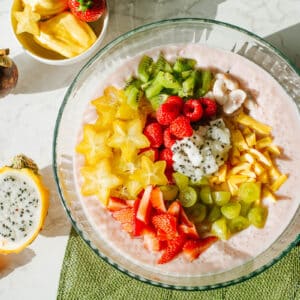 coconut milk sago topped with and surrounded by tropical fruits sucg as dragon fruit, star fruit, mangosteen, jackfruit, etc.