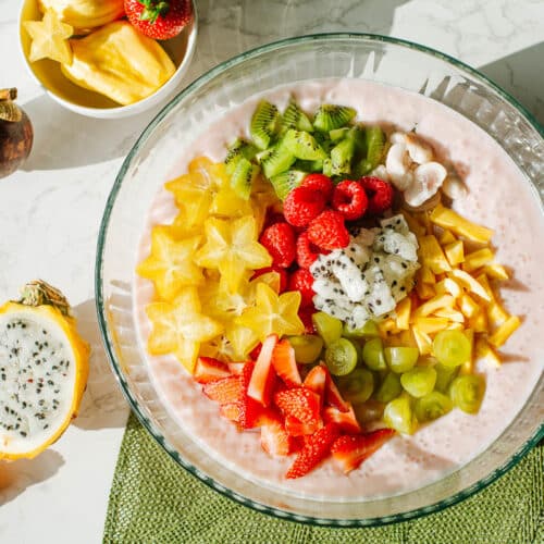 coconut milk sago topped with and surrounded by tropical fruits sucg as dragon fruit, star fruit, mangosteen, jackfruit, etc.